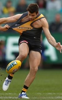 AFL 2016 Rd 12 - Richmond v Gold Coast MELBOURNE, AUSTRALIA - JUNE 12: Trent Cotchin of the Tigers is tackled by Gary Ablett of the Suns during the 2016 AFL Round 12 match between the Richmond Tigers and the Gold Coast Suns at the Melbourne Cricket Ground on June 12, 2016 in Melbourne, Australia. (Photo by Michael Willson/AFL Media)